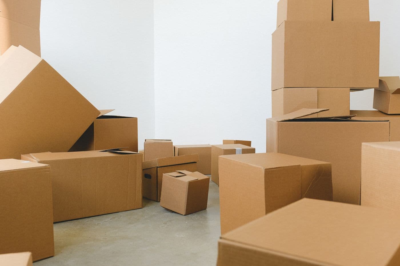 Cardboard moving boxes of different sizes arranged in a room